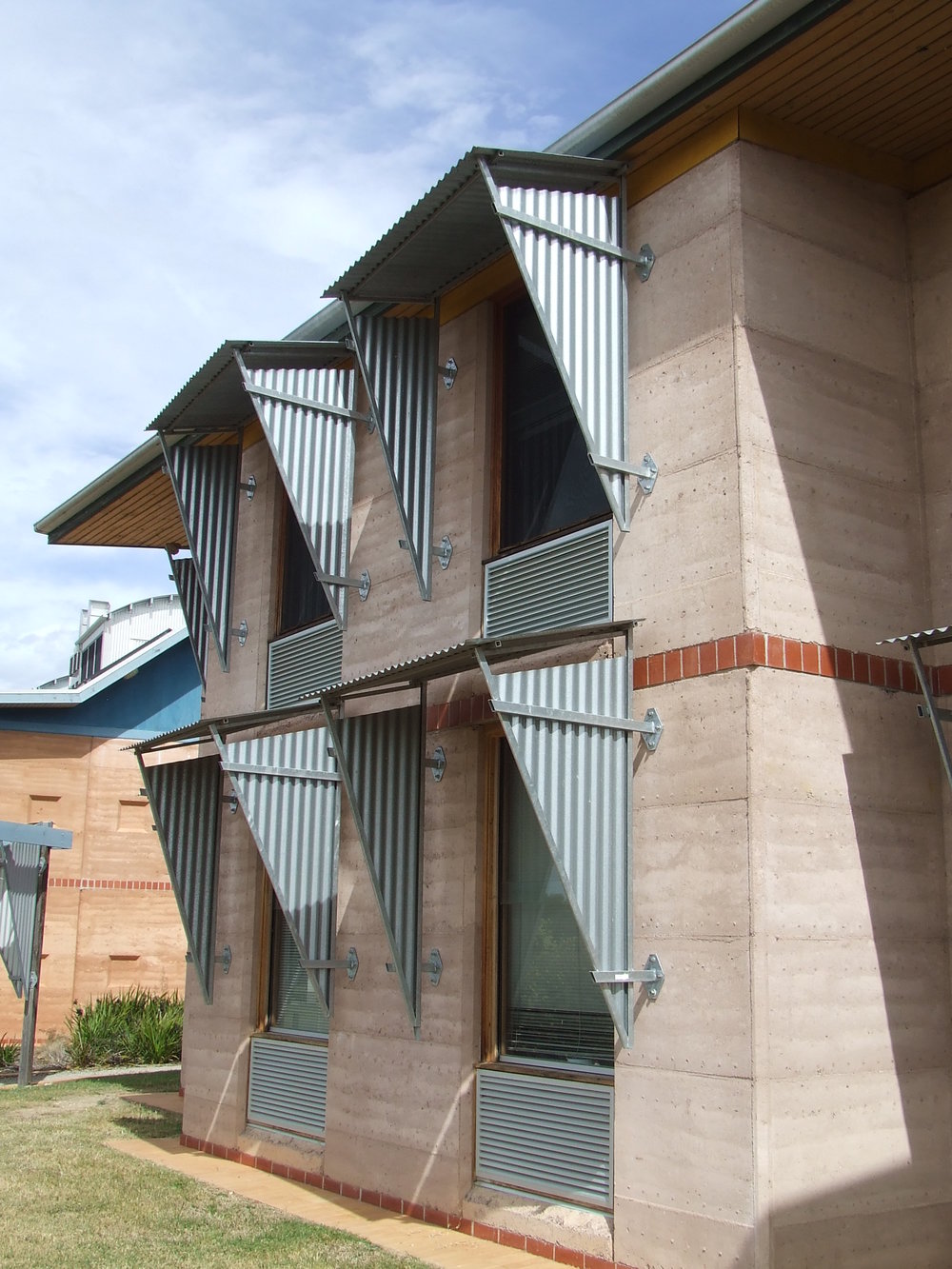  These north facing office windows all feature individual sun shading devices which cast shadow on the glass throughout the day. 